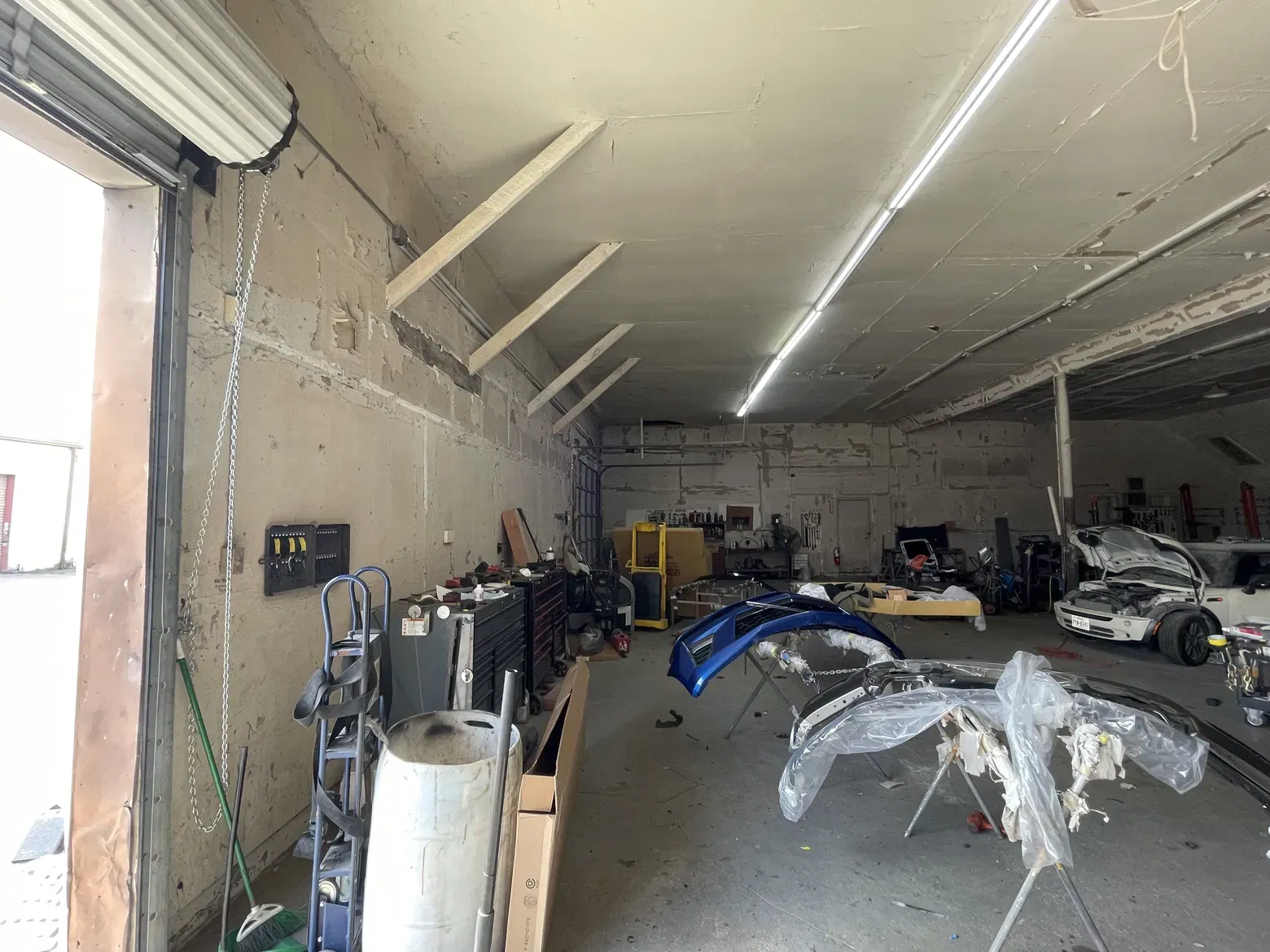 Shop bay interior, high ceilings, roll-up doors